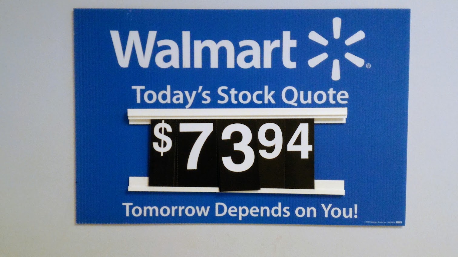 Walmart stock quote at $73.94 with the message 'Tomorrow depends on you'—a symbol of the American Dream, economic mobility, and capitalism in the 21st century